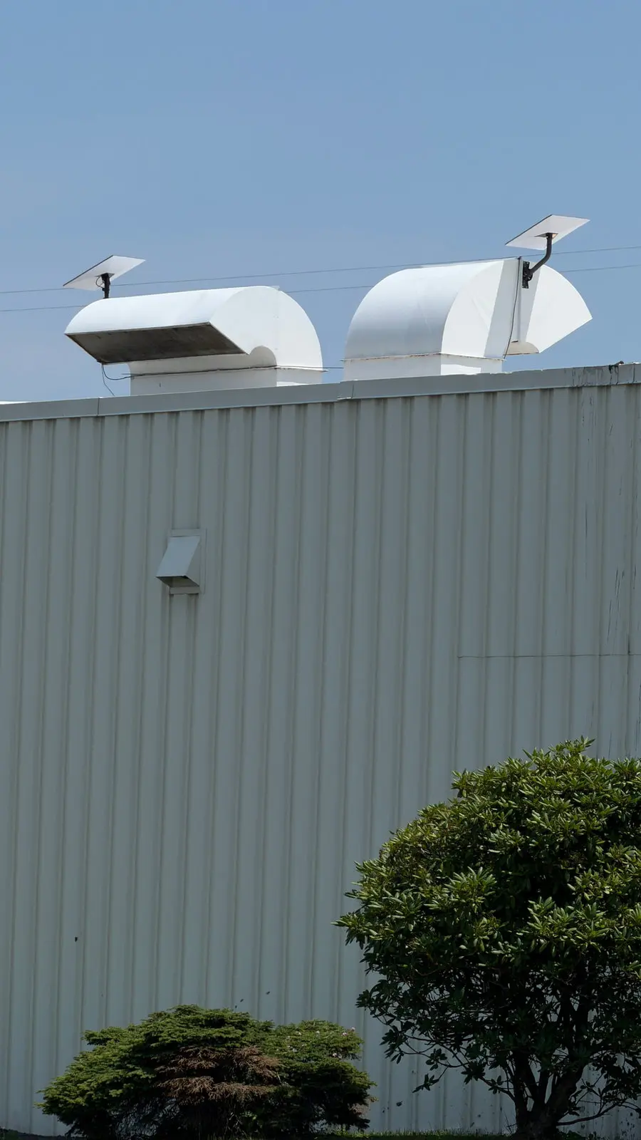 A Starlink dish on rooftop equipment of a commercial building.